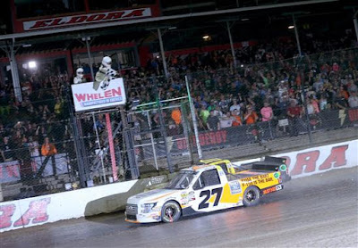 Chase Briscoe, driver of the #27 Ford Ford, takes the checkered flag to win the NASCAR Camping World Truck Series Eldora Dirt Derby at Eldora Speedway on July 18, 2018 in Rossburg, Ohio. 