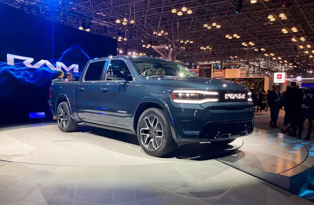 A wide shot of a blue 2024 Ram 1500 REV electric pickup truck at the New York auto show.