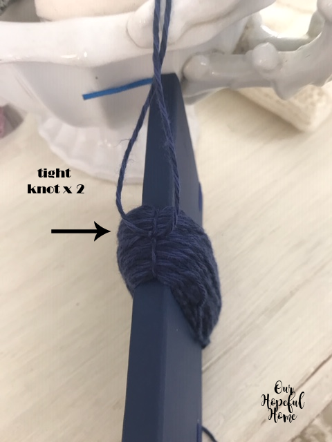 tight yarn knot on top of DIY tassel