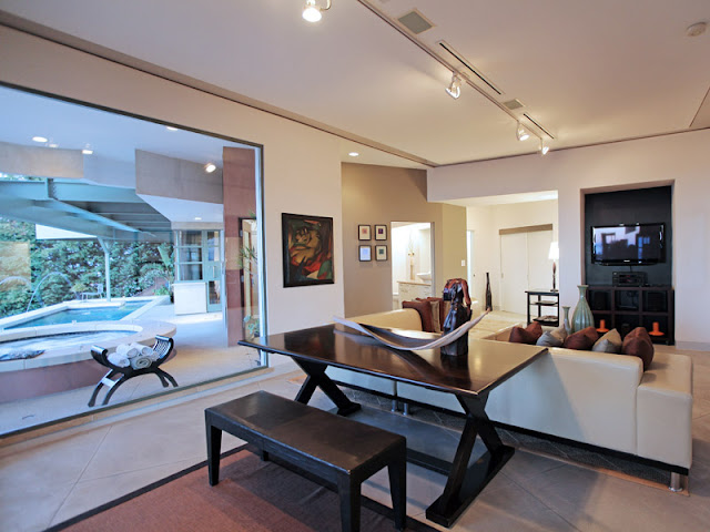 Photo of wooden black table and sitting bench behind the couch in the living room