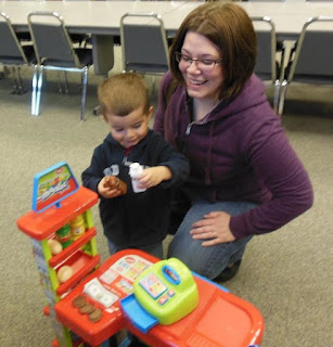 child and parent playing with toy store