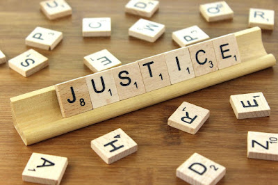 scrabble tiles spell justice