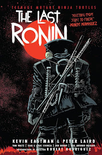 The cover of "Teenage Mutant Ninja Turtles: The Last Ronin" by Esau Escorza, Isaac Escorza, and Luis Antonio Delgado. A dramatic close-up reveals the back of a lone, cloaked ninja, their dark attire blending seamlessly with the ominous, speckled night sky. Two swords are strapped to their back, hinting at a warrior's readiness. The backdrop is punctuated by a vibrant, stylized red sun, a stark contrast against the brooding darkness, creating a visually arresting image that speaks volumes about mystery, action, and impending conflict. The overall mood is one of intense anticipation and suspense.