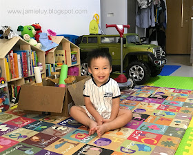 Toddler happy with Ikea dollhouse and jeep