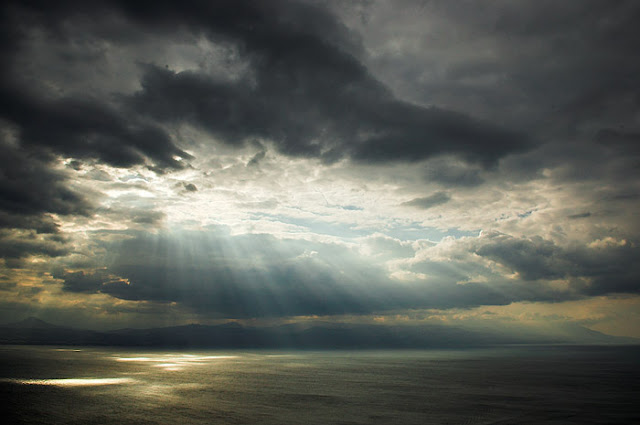 light rays shining from clouds