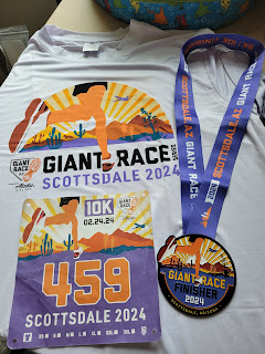 The Giant Race - Scottsdale 2024 (held February 24, 2024) finisher swag, showing front & back of the technical shirt, medal, and racing bib.