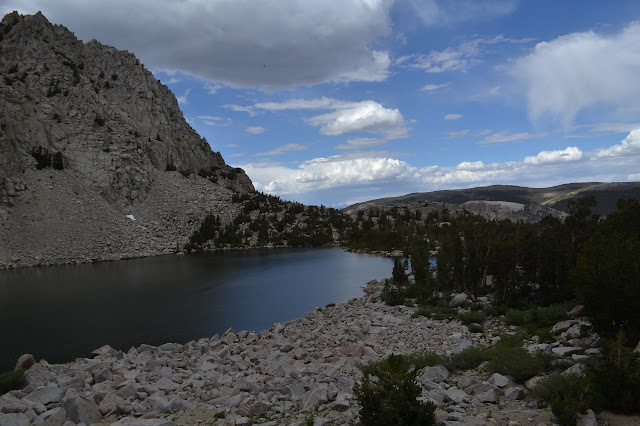 grey rock surrounding a wide blue pool