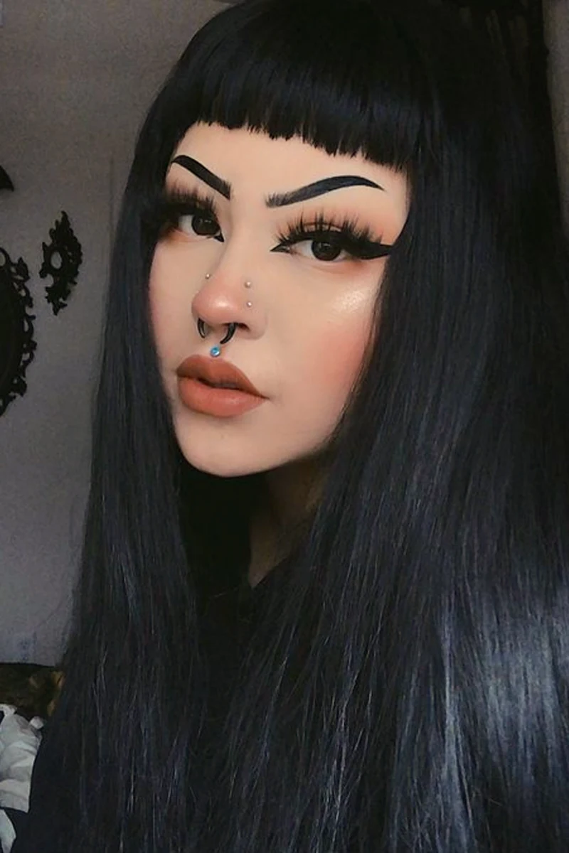 close-up portrait of a young, beautiful woman with goth eyeliner makeup look