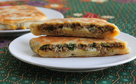 Food Lust People Love: Spicy lamb murtabak starts with a soft dough stretched thin, then filled with seasoned ground lamb and cooked till crispy and golden. Start a day ahead to allow time for the dough to rest overnight in the fridge.