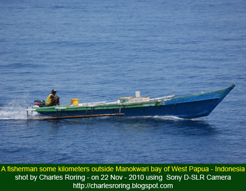 fisherman and his boat in West Papua