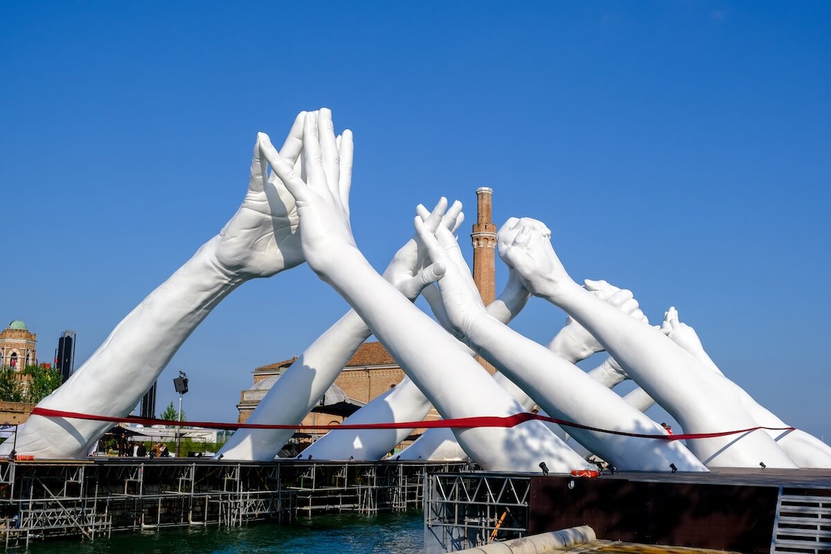 Monumental Installation Of Hands Creating A Bridge Of Unity In Venice