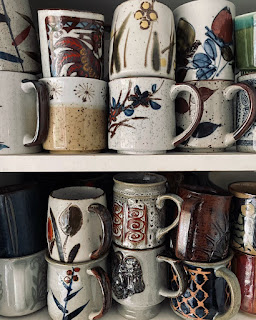 Shelves of stacked mugs