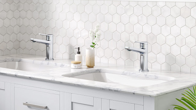 White bathroom with vessel sinks and hexagon tile backsplash.