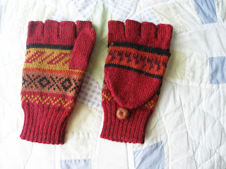 red multicolored knitted fingerless mittens with alpacas on them