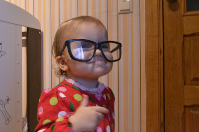 small girl wearing big glasses, smiling, funny