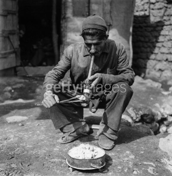 Opium Smoker circa 1955,A man smoking opium in a village in Iran. (Photo by Three Lions:Getty Images).jpg