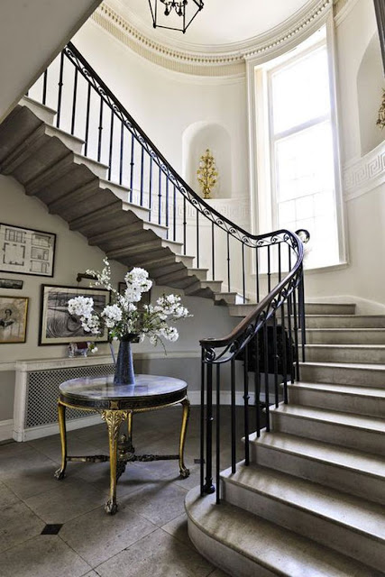 white foyer staircase with gray tile entry white walls