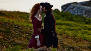Demelza and Ross Poldark kiss on the cliff after the pilchard catch