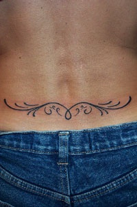 Minimalist tribal tattoo on lower back