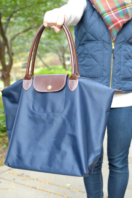 navy longchamp purse with a navy puffer vest