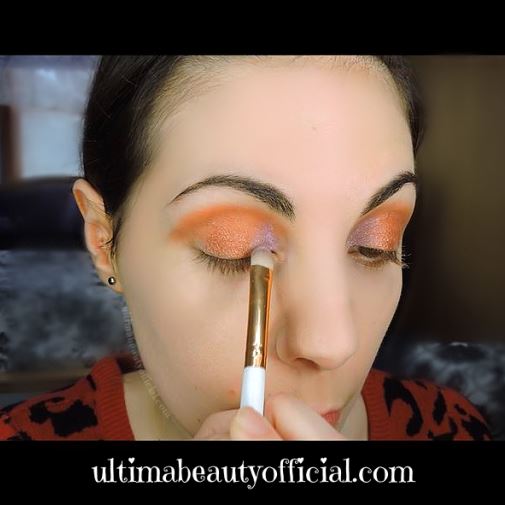 Ultima Beauty applying "Sugar Rush" with a makeup brush