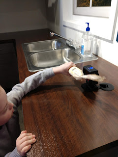 a boy scans a toy corn cob with the fact scanner at  the Stockyards Ag Experience museum in Sioux Falls, South Dakota