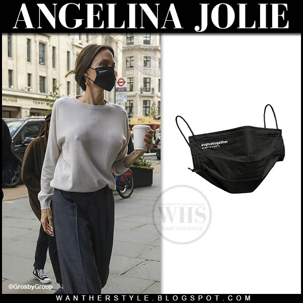 Angelina Jolie in beige sweater, grey trousers and black face mask