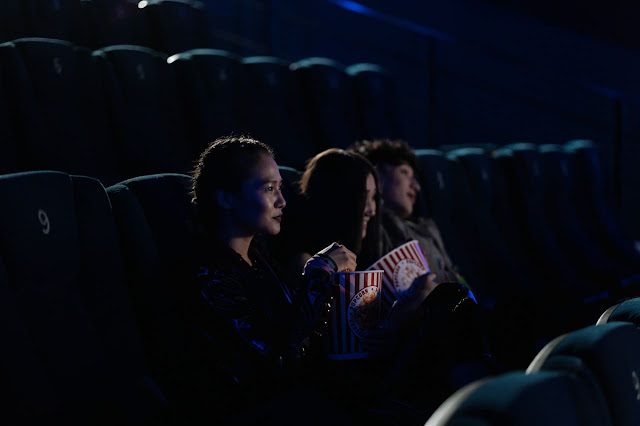 people watching movie in theatre