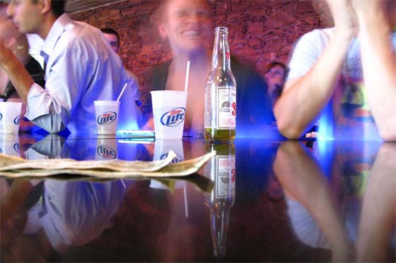 College kids drinking beer at a bar at the University of Kansas in Lawrence, Kansas.