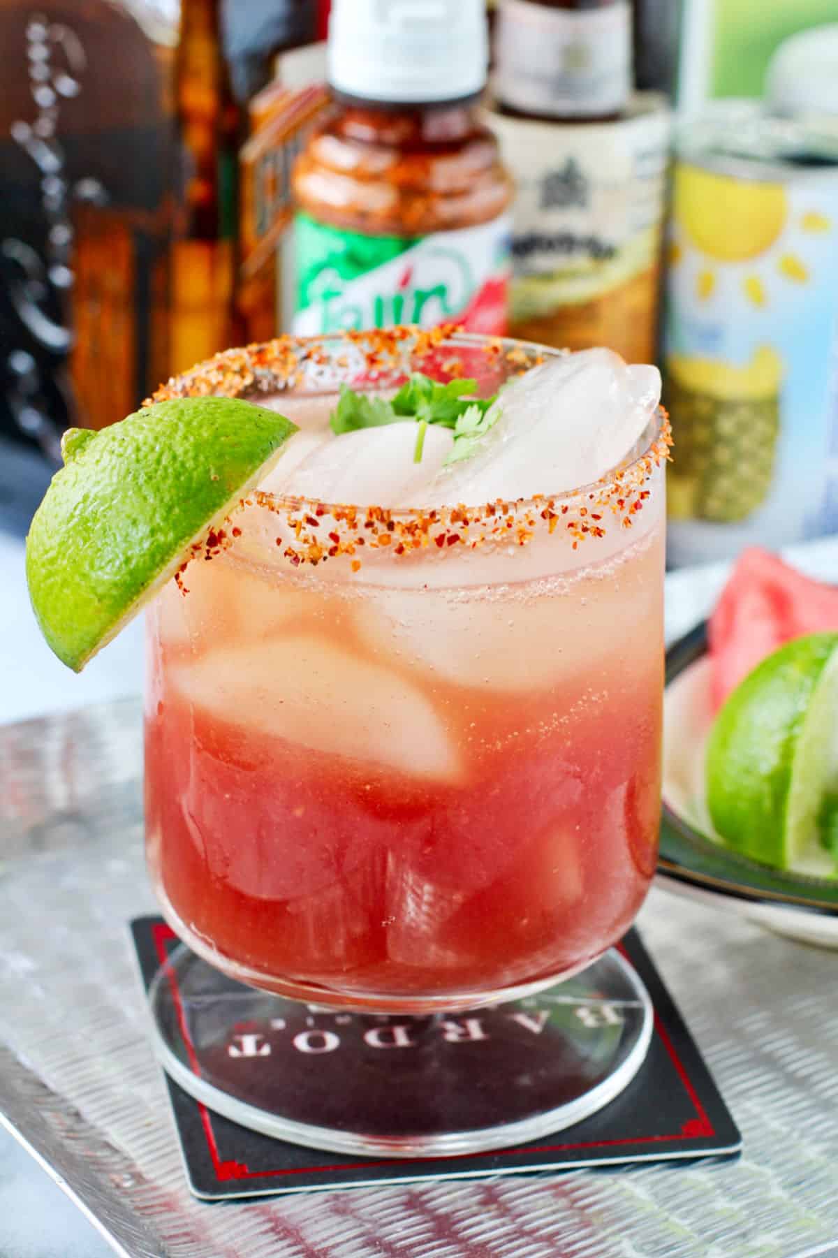 Watermelon Rum and Sparkling Wine Cocktail and Ingredients on a Metal Tray.