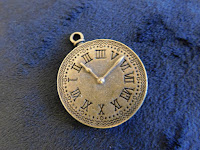 A brass clock pendant