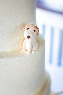 dog statue sitting on wedding tier cake