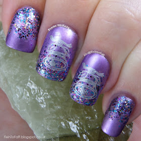 Metallic purple nails with a glitter gradient, topped with stamped silver bells.