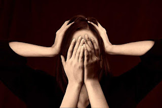 Woman holding her face because of stress