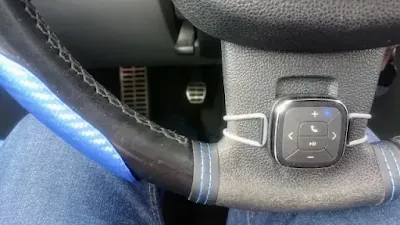 tunai button attached to car steering wheel