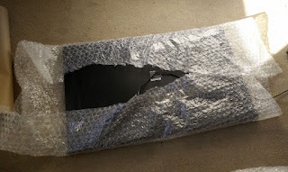 Wrapping up the TV in lots of bubble wrap