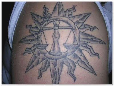 This is a typical Libra tattoo for men. The things around the zodiac sign 