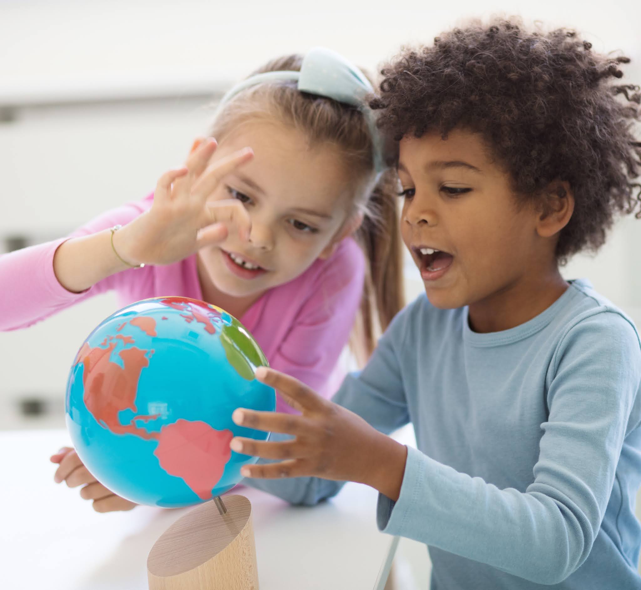 cosmic education. a blueprint for peace. children exploring globe.