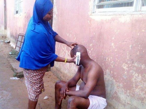 woman giving her husban a haircut in lagos