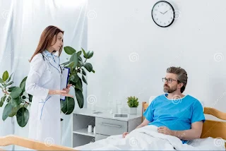 A personal injury lawyer in LA consulting with a client in a hospital bed about her case
