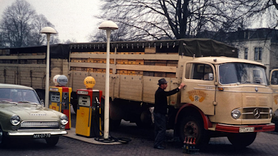 Mercedes 338 and Ford Cortina Fueling at Shell Gas Station in Historic Photo.