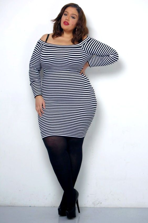 Lovely curvy wearing a stripe dress with black tights and black pumps