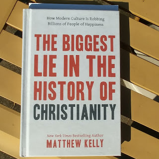 Picture of the book "The Biggest Lie in the History of Christianity" (Matthew Kelly) on a patio table.