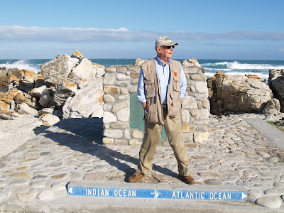 Bill Arnold standing at Cape Agulhas, South Africa
