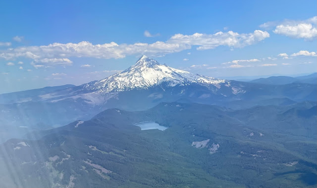 A beautiful view of both lost lake, evergreen trees as far as the eye can see in all directions, and Mt. Hood in the distant background.