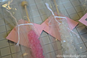 Want a tasty (and easy) bridal shower or engagement party favor? Make our DIY "She Got Her Rock" Rock Candy Favor from www.abrideonabudget.com. Even better, there's a free printable for the tags in the post too!