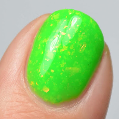 bright green nail polish with flakies close up swatch