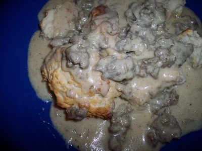 Plate of sausage gravy on biscuits.