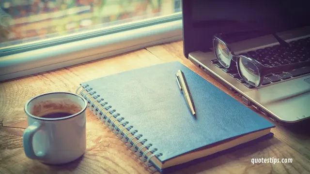 cheerful office desk setup with a laptop, a motivational quote card, and bright sunlight streaming through the window, symbolizing productivity and positivity.