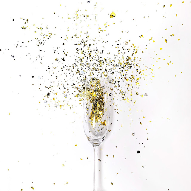 champagne glass with glitter confetti:Photo by Anastasiia Rozumna on Unsplash